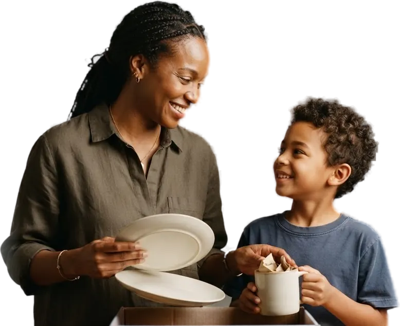 A mother and son packing dishes into a moving box