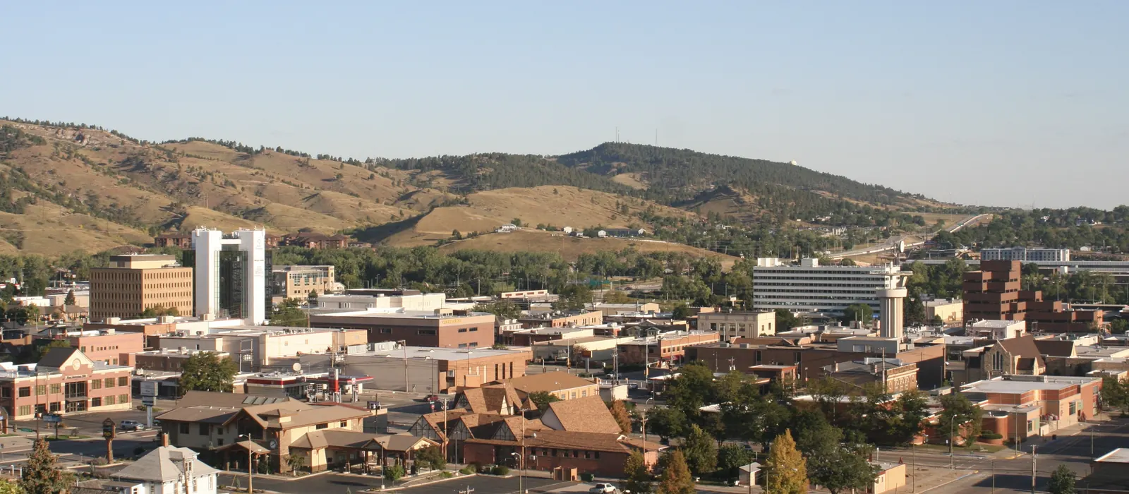 Downtown Rapid City with the Black Hills foothills behind it